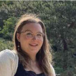 Smiling woman with glasses, outdoors