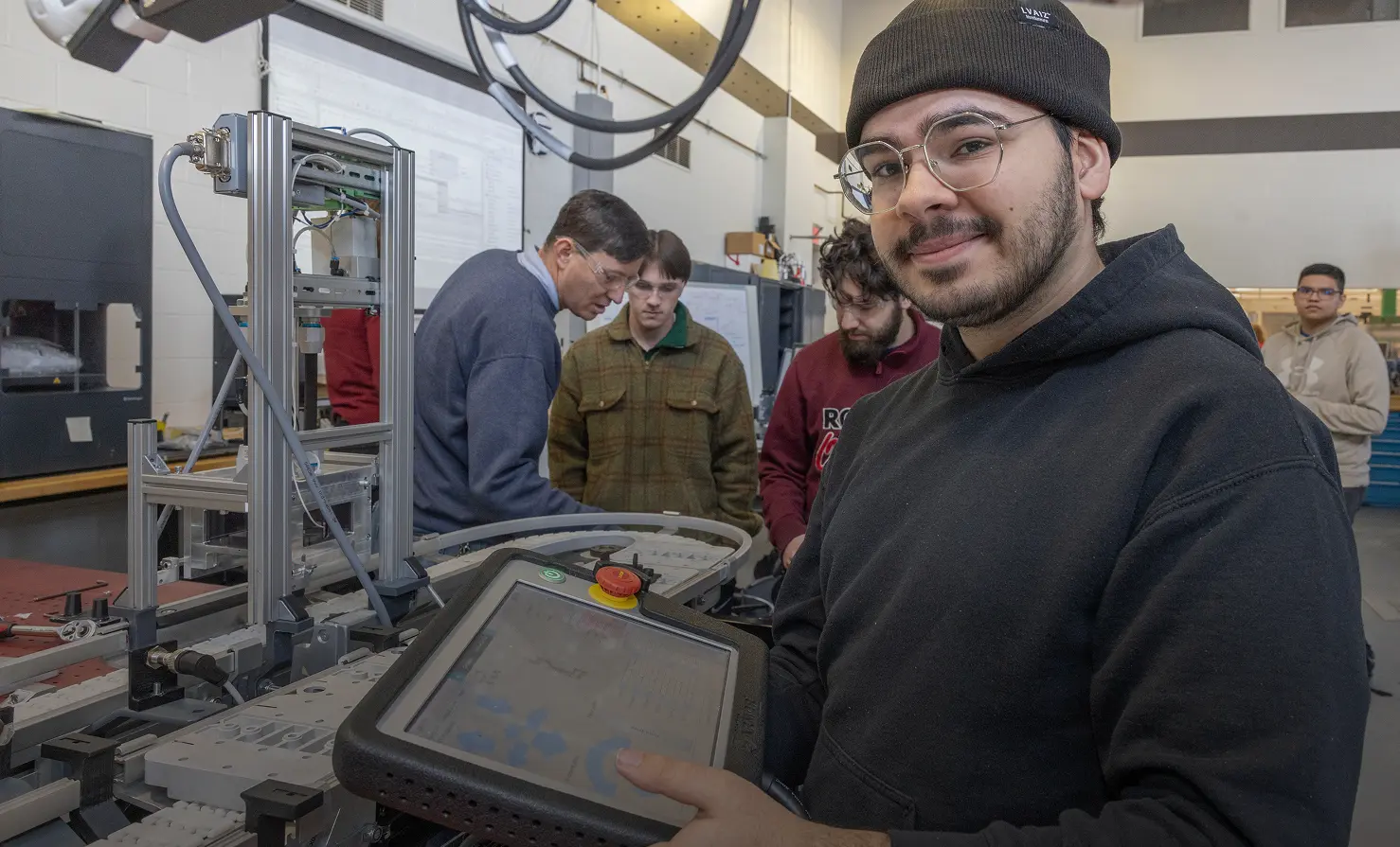 Man with tablet in black with a group