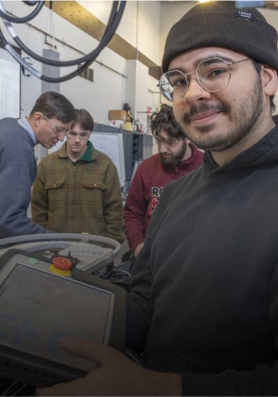 Man with tablet in black with a group