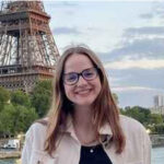 Smiling woman in front of Eiffel Tower