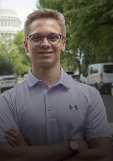Kid in white shirt standing on street