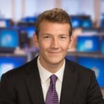 Man smiling for camera in suit