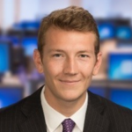 Man in suit smiling at camera